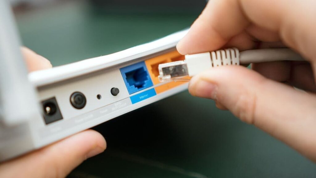 Person unplugging a Wi-Fi router to restart it.