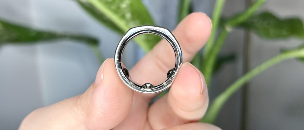Close up of hand holding Oura Ring Gen 3