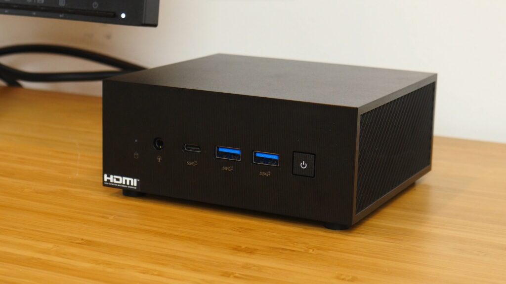 ASUS PN64 mini PC on a desk.