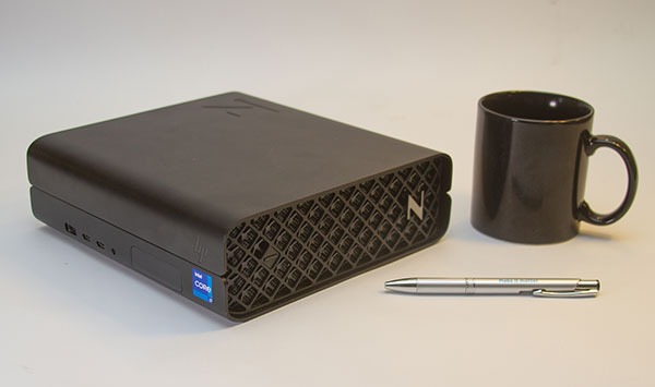 HP Z2 Mini G9 mounted next to a mug and pen for comparison