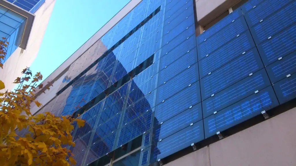 Solar panel arrays on futuristic city skyscrapers generating clean energy. Green technology in 2025